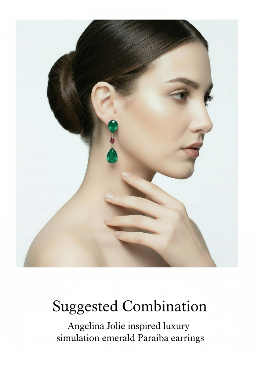 Green teardrop-shaped gemstone earrings with pink gemstones on a hand against a white background