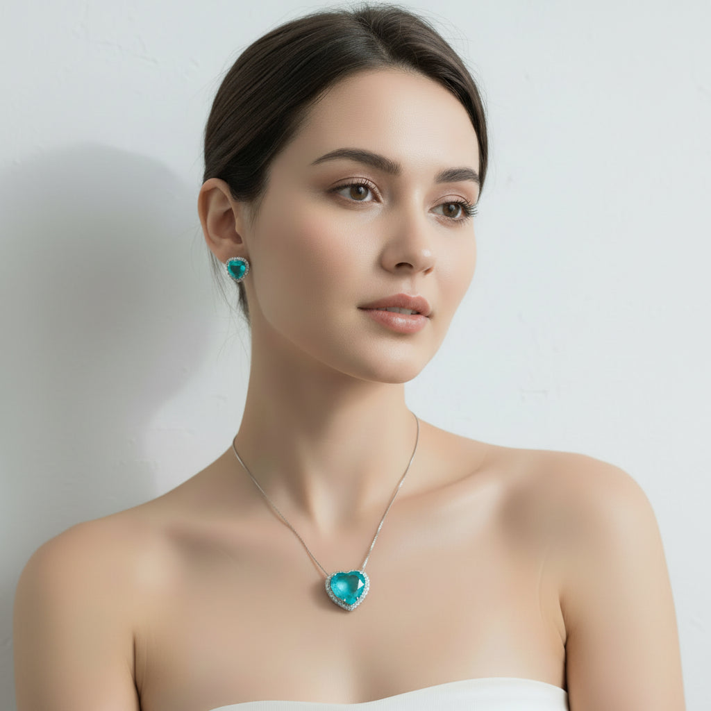 Woman wearing a turquoise heart-shaped necklace and earrings on a white background