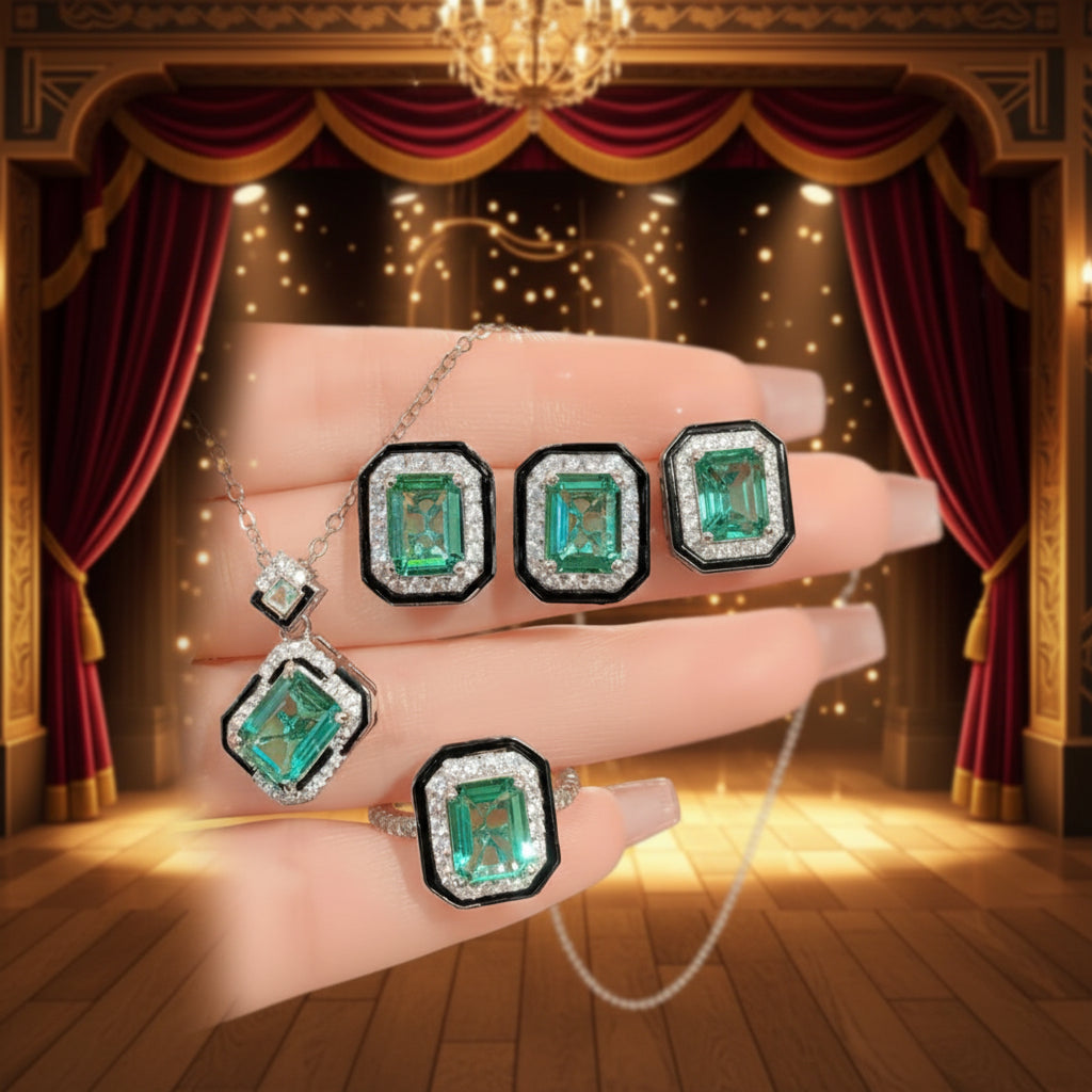 Emerald jewelry set on a hand with a theatrical backdrop