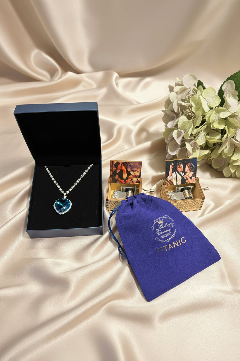 Blue gemstone necklace with packaging and 'Titanic' theme on a wooden surface
